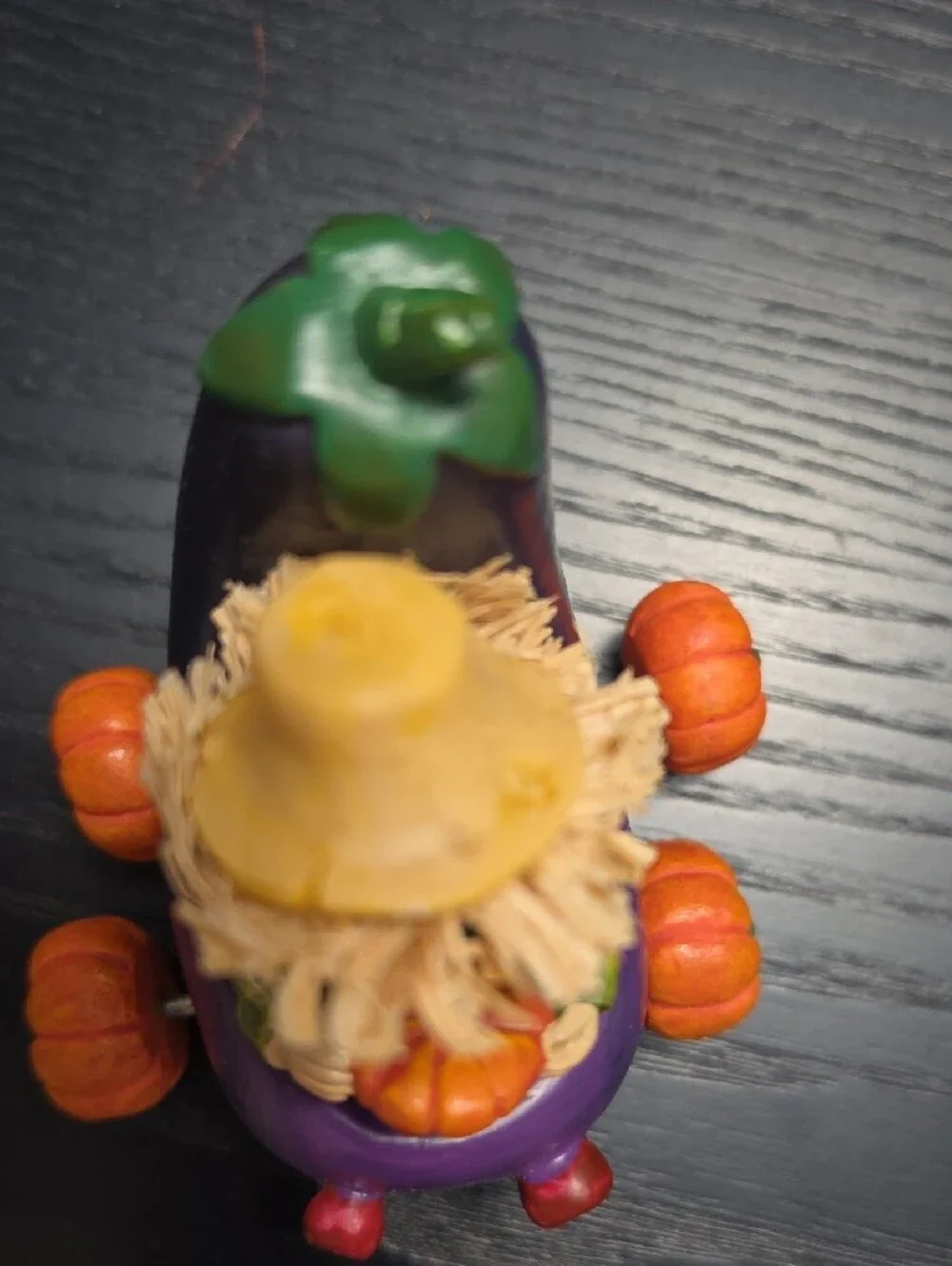 Autumn figurine of a scarecrow in a Eggplant cart